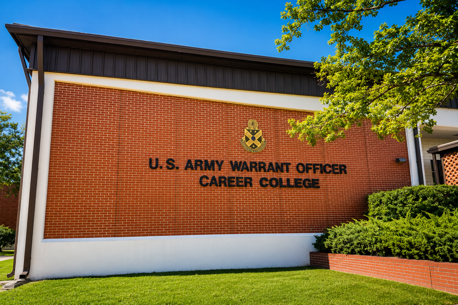 U.S. Army Warrant Officer Career College seal and name on the exterior of a red brick building.